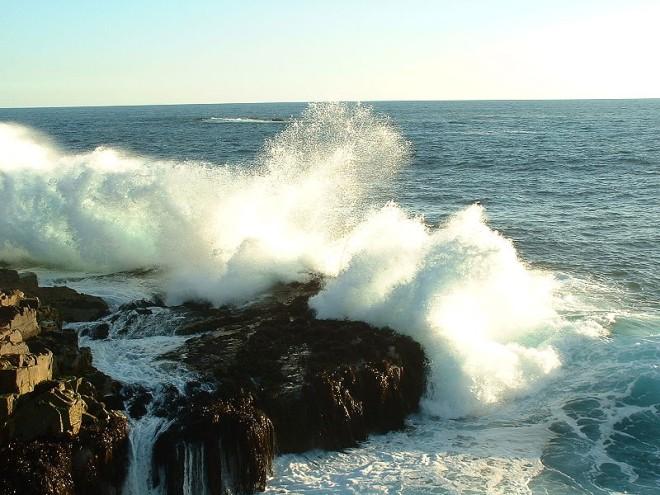 The waves crash ferociously into the rocks along a coastline in Chile. The unforgiving Chilean coastline waves send water flying in all directions.